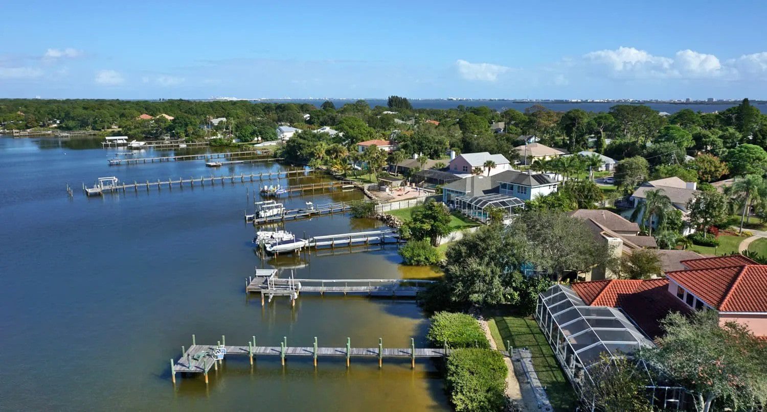Several waterfront piers in a residential area